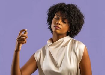 Woman spraying perfume