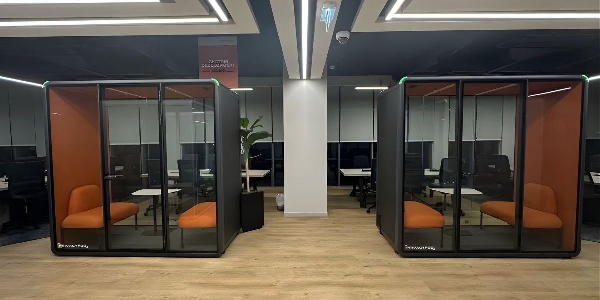 Two soundproof office privacy pods in a modern workspace