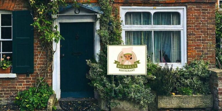 Borcelle Restaurant sign in front of a rustic brick cottage