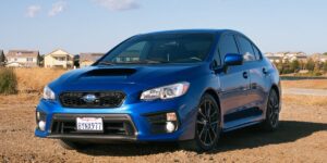 Vehicle speeding through dusty mountain road.