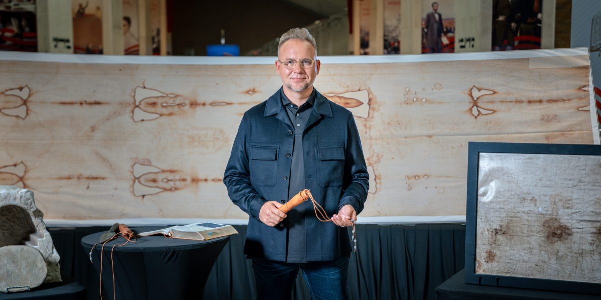 Dr. Jeremiah Johnston with a full size replica of the Shroud of Turin and a replica Roman flagrum. Photo courtesy of Dr. Jeremiah Johnston.