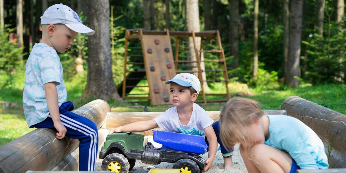 Alt text: Children playing outdoors with shovel.